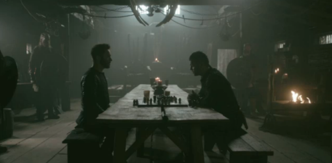 Jonathan Rhys Meyers as Bishop Heahmund, and Alex Høgh as Ivar the Boneless play a board game in season 5, episode 7 of History's Vikings.